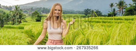 Young Woman Traveler On Beautiful Jatiluwih Rice Terraces Against The Background Of Famous Volcanoes