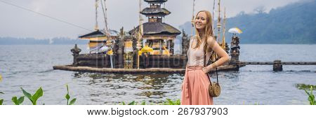 Young Woman Traveler In The Background Of Pura Ulun Danu Bratan, Bali. Hindu Temple Surrounded By Fl