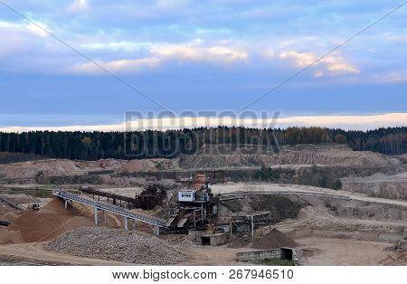 Aerial View Of Opencast Mining Quarry With Lots Of Machinery At Work - View From Above. Production U