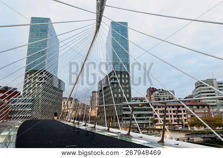 View Of A Zubizuri Bridge,over The Nervion River, In A Cloud Day, Between The Towers Of Bilbao, Vizc