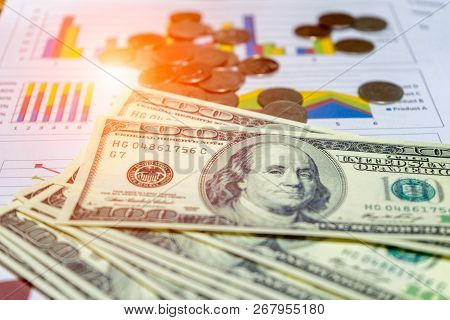 Banknote And Coins Depicted On Economic Graphs Dollar Currency, Financial Investment Concepts That A