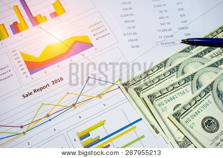 Banknote And Coins Depicted On Economic Graphs Dollar Currency, Financial Investment Concepts That A