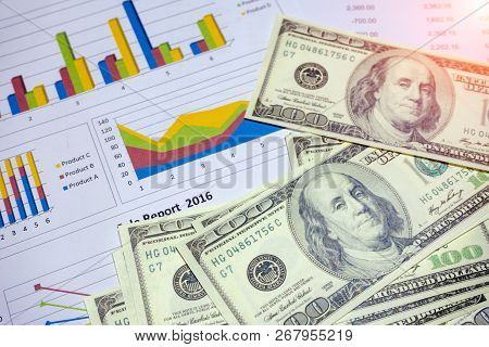 Banknote And Coins Depicted On Economic Graphs Dollar Currency, Financial Investment Concepts That A