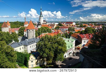 Panoramic View Of Old Town Of Tallinn With Traditional Red Tile Roofs, Medieval Churches, Towers And
