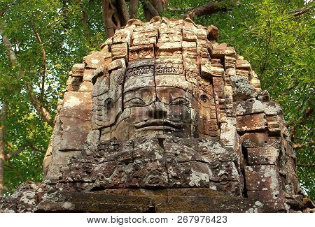 Face Tower With Ancient Carved Smiling Buddhist Face Of Lokeshvara Crowning Western Gopura Of Ta Som