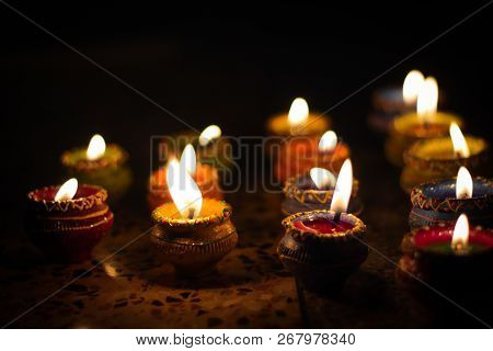 Earthen Diya Lamp Lighting With Candles On The Occasion Of Diwali And Sandhi Pujo