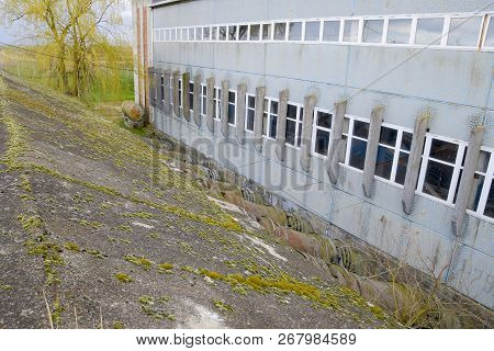 Outlet Pipes Of A Water Pumping Station. Pipes Of Large Diameter. Wall, Building