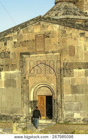 The Main Entrance With Arched Cornices And A Wooden Door In The Monastery Saghmosavank,standing On T