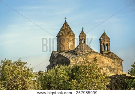 Saghmosavank Monastery In The Autumn Evening Among The Orchard, Located Near The Town Of Ashtarak