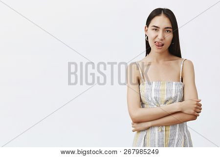 Yami. Portrait Of Confident And Sensual Adult Woman In Stylish Outfit, Showing Tongue, Holding Hands