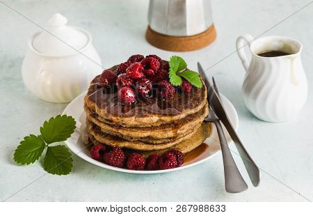 Gluten-free Green Buckwheat Pancakes With Fresh Berries And Maple Syrup. Delicious Vegan Breakfast W