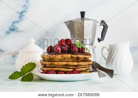Gluten-free Green Buckwheat Pancakes With Fresh Berries And Maple Syrup. Delicious Vegan Breakfast W
