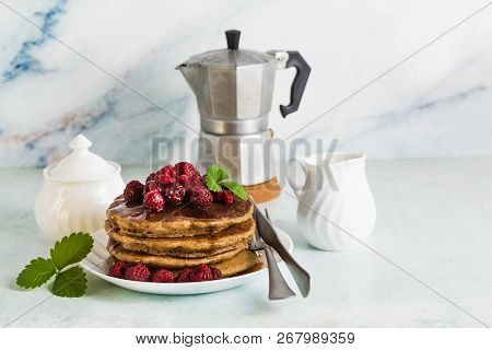 Gluten-free Green Buckwheat Pancakes With Fresh Berries And Maple Syrup. Delicious Vegan Breakfast W