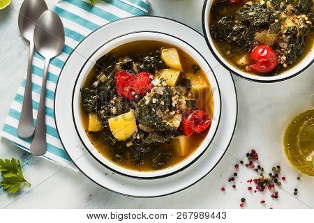 Vegan Winter Kale Soup With Buckwheat , Cherry Tomatoes And Potatoes. Tasty Full Vegetable Food For