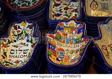 Painted Souvenir Plates On The Counter In The Store Of Jerusalem, Israel. National Ornament On A Pla