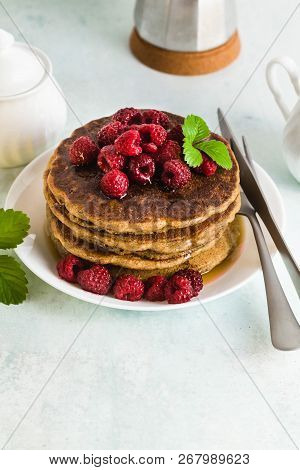 Gluten-free Green Buckwheat Pancakes With Fresh Berries And Maple Syrup. Delicious Vegan Breakfast W