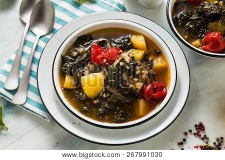 Vegan Winter Kale Soup With Buckwheat , Cherry Tomatoes And Potatoes. Tasty Full Vegetable Food For