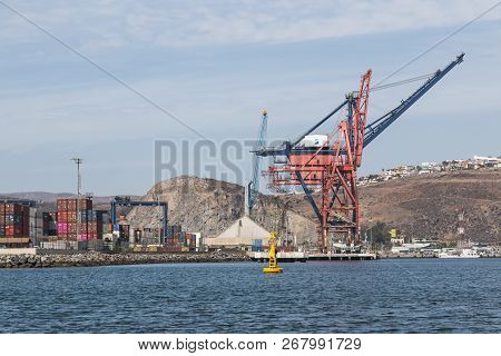 Ensenada, Mexico - October 22, 2018:  Shipping Containers Line The Docks Near Panamax Shipping Crane