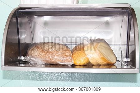 Loaf And Rye Bread Is In The Bread Box In A Cellophane Bag. Close Up.