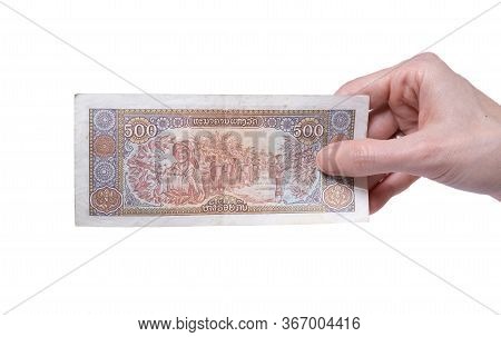 Female Hand Holding A 500 Kip 1988 Banknote Currency Isolated On A White Background. Denomination Of