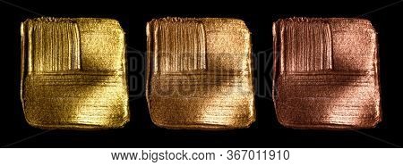 Creative brushstrokes of gold paint isolated on a black background. Gold paint texture.Acrylic gold paint. Smears of cosmetics, blush, highlighter, eye shadow, lipstick.