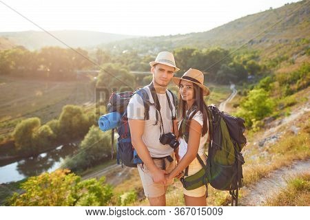 Romantic Couple Hikkers With Backpacks On Hikking The Nature.