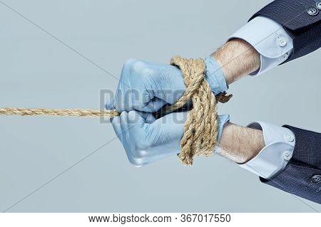 Business Man Pulling And Bond Tied With Rope. Concept Business Hands Are Tied With A Rope. Concept B
