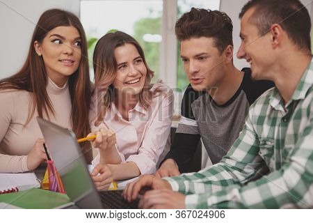 Group Of Young People Studying Together At College Classroom