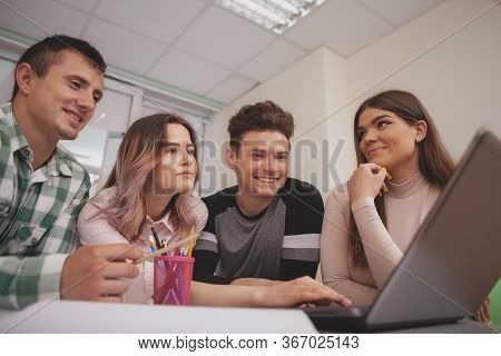 Group Of Young People Studying Together At College Classroom