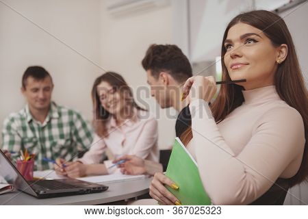 Group Of Young People Studying Together At College Classroom