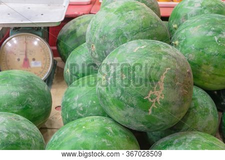 Group Of Watermelons Heap Next To A Weight At Fruit Stand In Geylang, Singapore