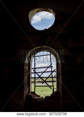Windows Of An Ancient Temple, In The Wall Of Red Brick, In The Form Of An Arch. The Hole In The Wall