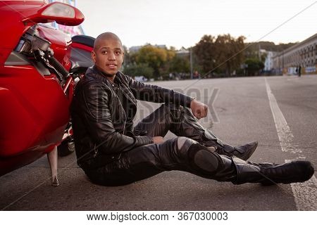 African Man On A Sport Motorbike In The City