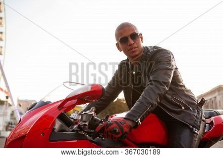 African Man On A Sport Motorbike In The City