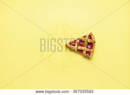 Single Slice Of Rhubarb Snd Strawberry Pie With A Lattice Crust On A Yellow Background. Flat Lay Wit