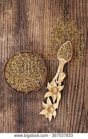 Freekeh grain health food in a bowl and daffodil lovespoon. Highly nutritious high in fibre, protein & treats IBS & digestive issues, with low gi for diabetics. Flat lay.