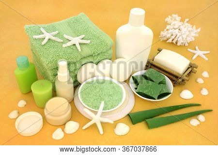 Natural vegan skincare beauty treatment with aloe vera, ex foliation & cleansing products on mottled yellow background. Huge skincare health benefits with aloe vera.