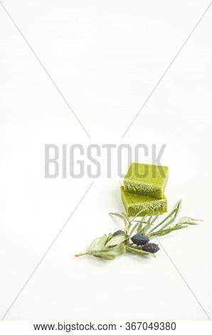 An Olive Branch On And A Handmade Olive Soap Bar On White Background With Copyspace.