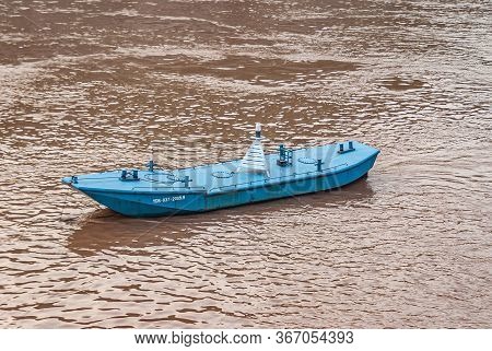Chongqing, China - May 8, 2010: Evening Light On Yangtze River. Closeup Of Blue Buoy Sloop On Brown 