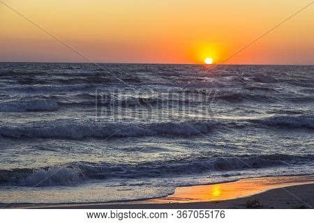 An Orange Sunset Evening Over The Black Sea With Big Dark Waves, Kinburn Foreland Shore, Ukraine