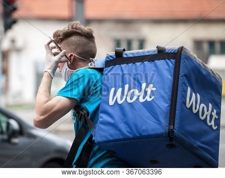 Belgrade, Serbia - May 5, 2020: Wolt Delivery Man Wearing A Face Mask Protective Respirator In Belgr