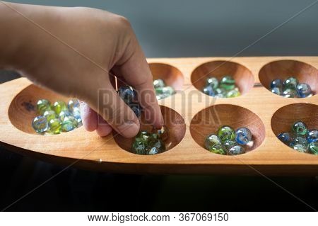 Hand Hold Glass Ball In Kalaha Game
