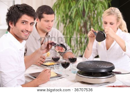 Przyjaciele jedzenie raclette