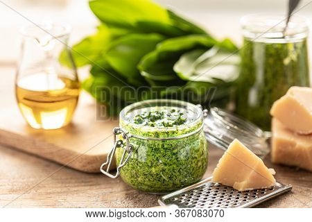 Wild Leek Pesto With Olive Oil And Parmesan Cheese In A Glass Jar On A Wooden Table. Useful Properti