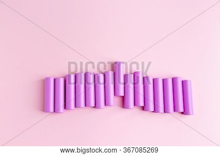 Power Batteries On A Pink Background. Monochrome. Flatlay Style.