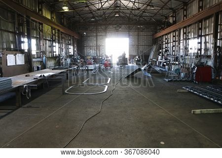 Factory Workers At An Industrial Site During A Safe Production Process.