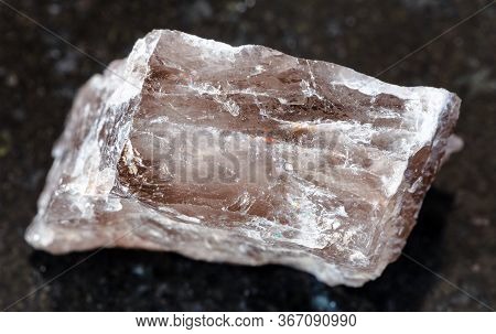 Closeup Of Sample Of Natural Mineral From Geological Collection - Raw Smoky Quartz Rock On Black Gra