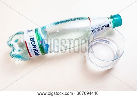 Moscow, Russia - May 10, 2020: Top View Of Lying Plastic Bottle Of Borjomi And Glass With Water On L
