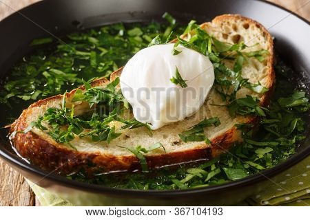 Recipe for This Garlicky Bread Soup Acorda With Poached Egg Close-up In A Plate. Horizontal