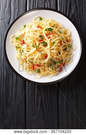 Naples Traditional Aglio E Olio Spaghetti Close-up In A Plate. Vertical Top View